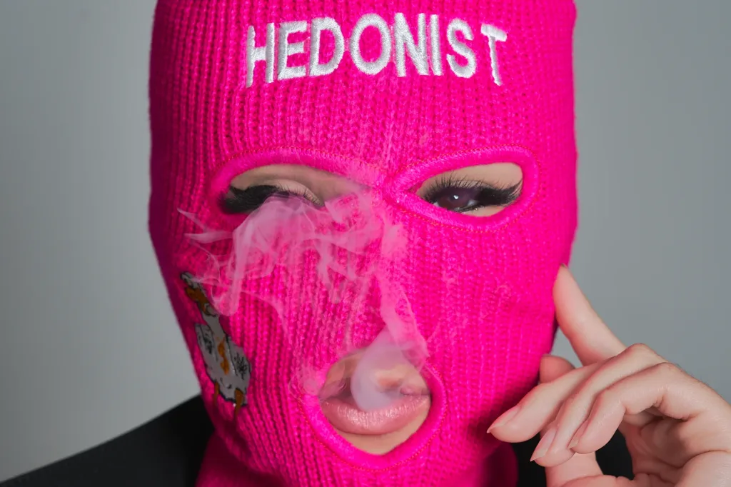 Close-up brand portrait of a model in a pink balaclava for Tokyo streetwear label Hedonist, by JG.